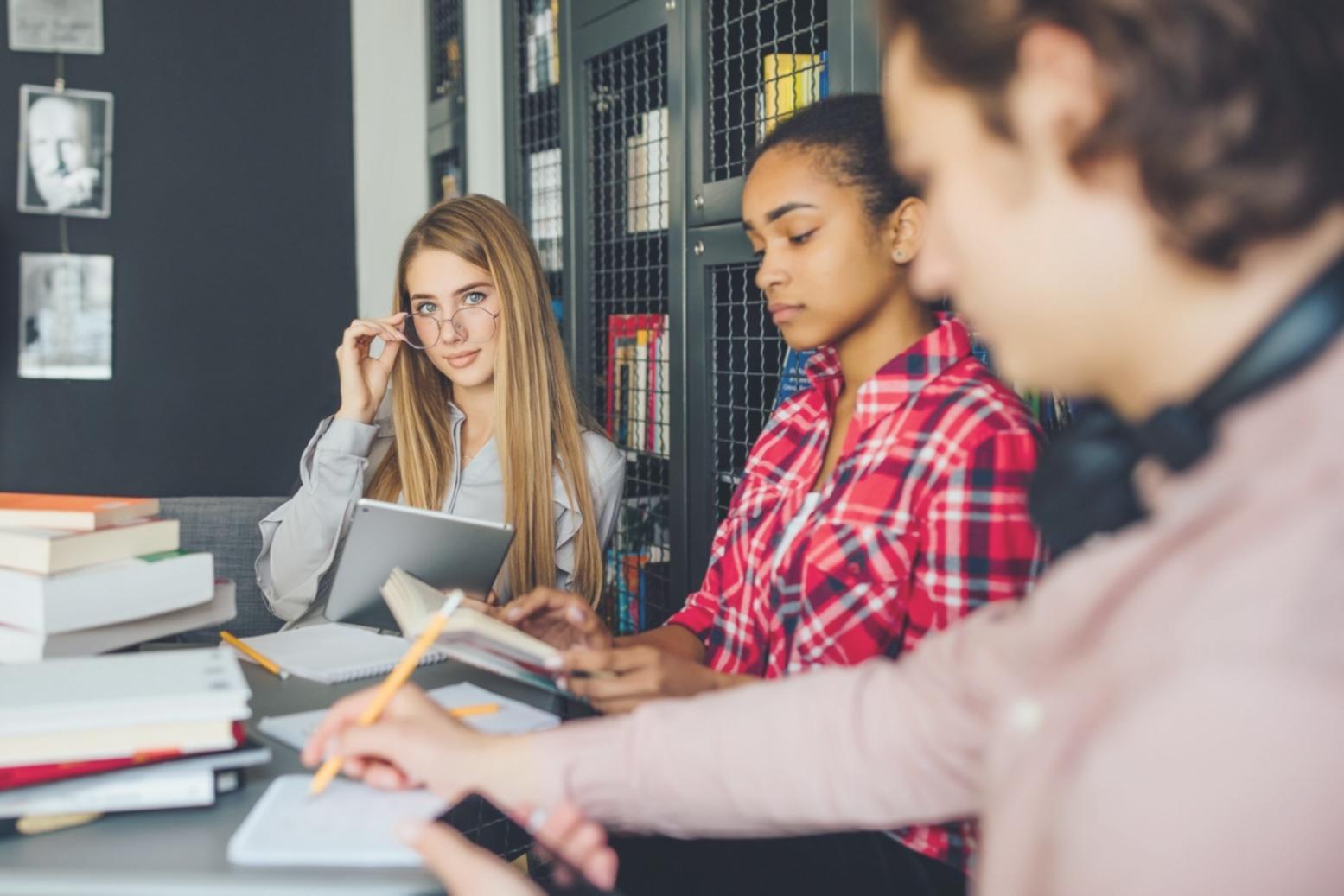 Professional home workspace setup showing organized desk with laptop, financial documents, and study materials ready for remote learning